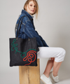 Thick denim tote bag with elaborate swirls in brightly coloured braided cord