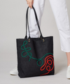 Thick denim tote bag with elaborate swirls in brightly coloured braided cord